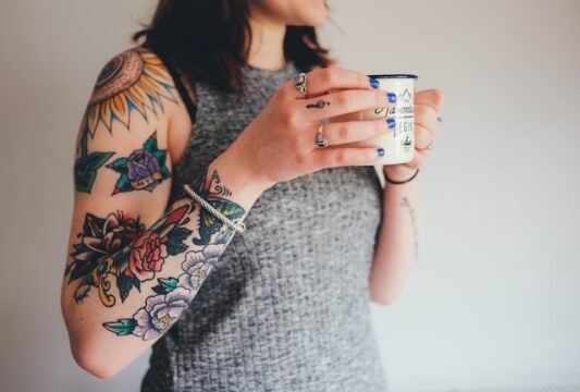 lady with a tattoos and a coffee